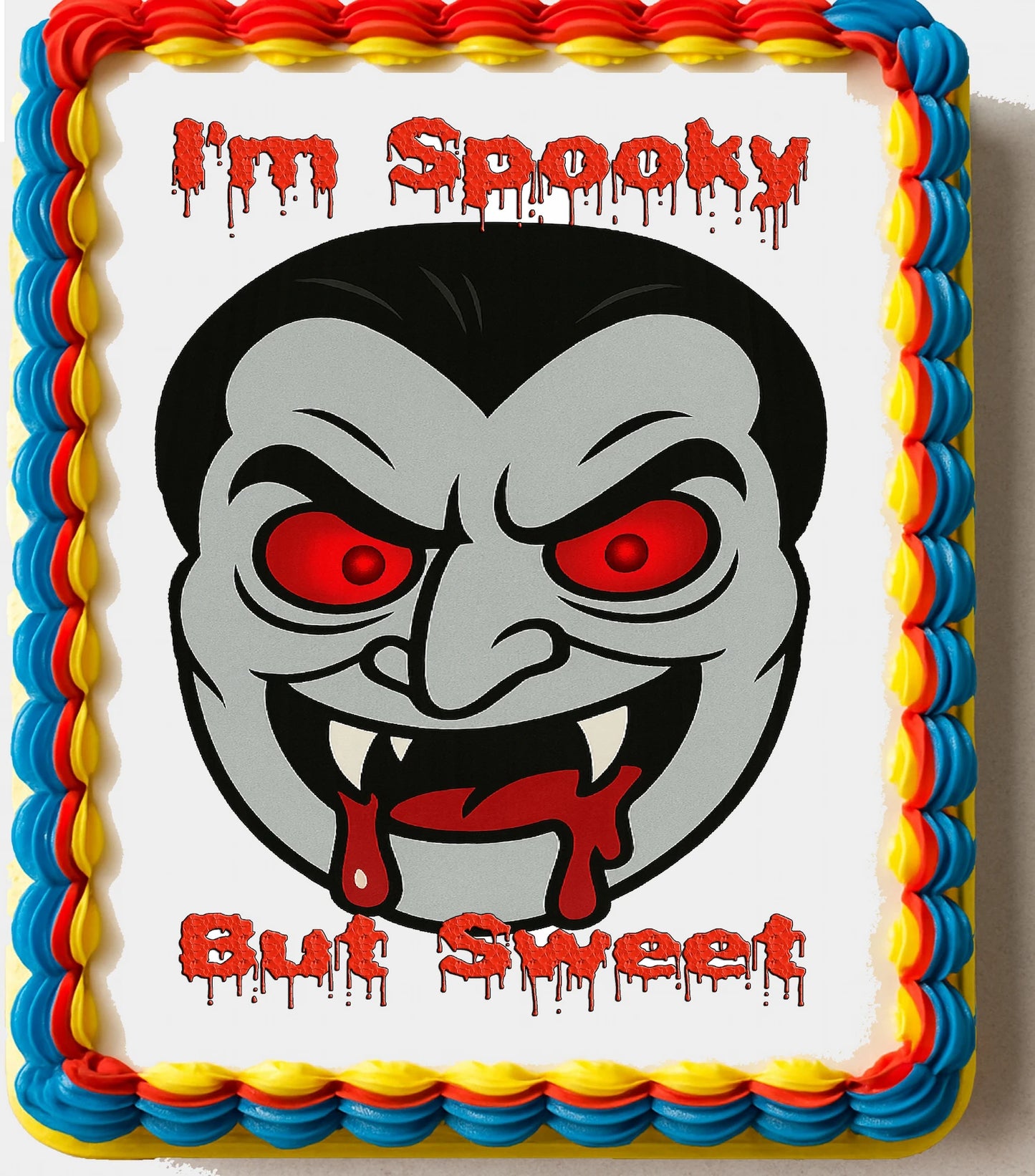 Cake with a vampire face design and text 'I'm Spooky But Sweet'