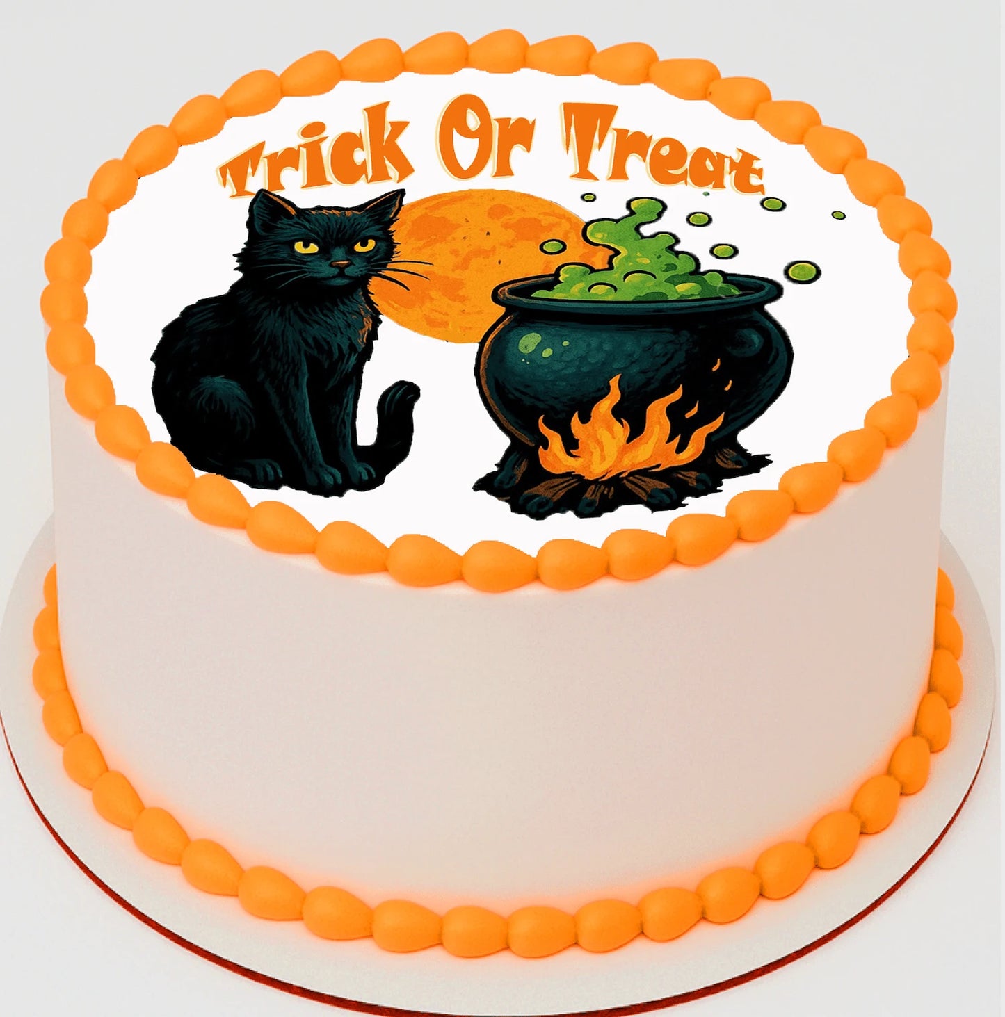Halloween-themed cake with black cat, cauldron, and 'Trick or Treat' text