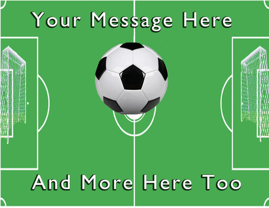 Soccer ball on a green field with text 'Your Message Here' and 'And More Here Too' on an edible icing image cake topper.