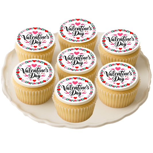 Valentine's Day cupcakes with decorative toppers on a white plate.