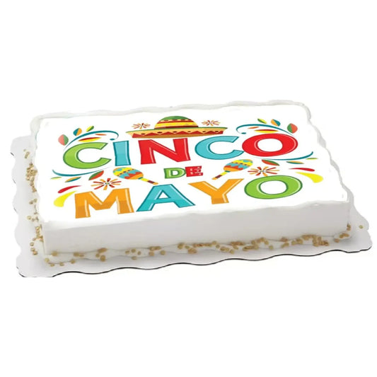 Cinco de Mayo edible icing cake topper with Cinco de Mayo lettering, on a white sheet cake.