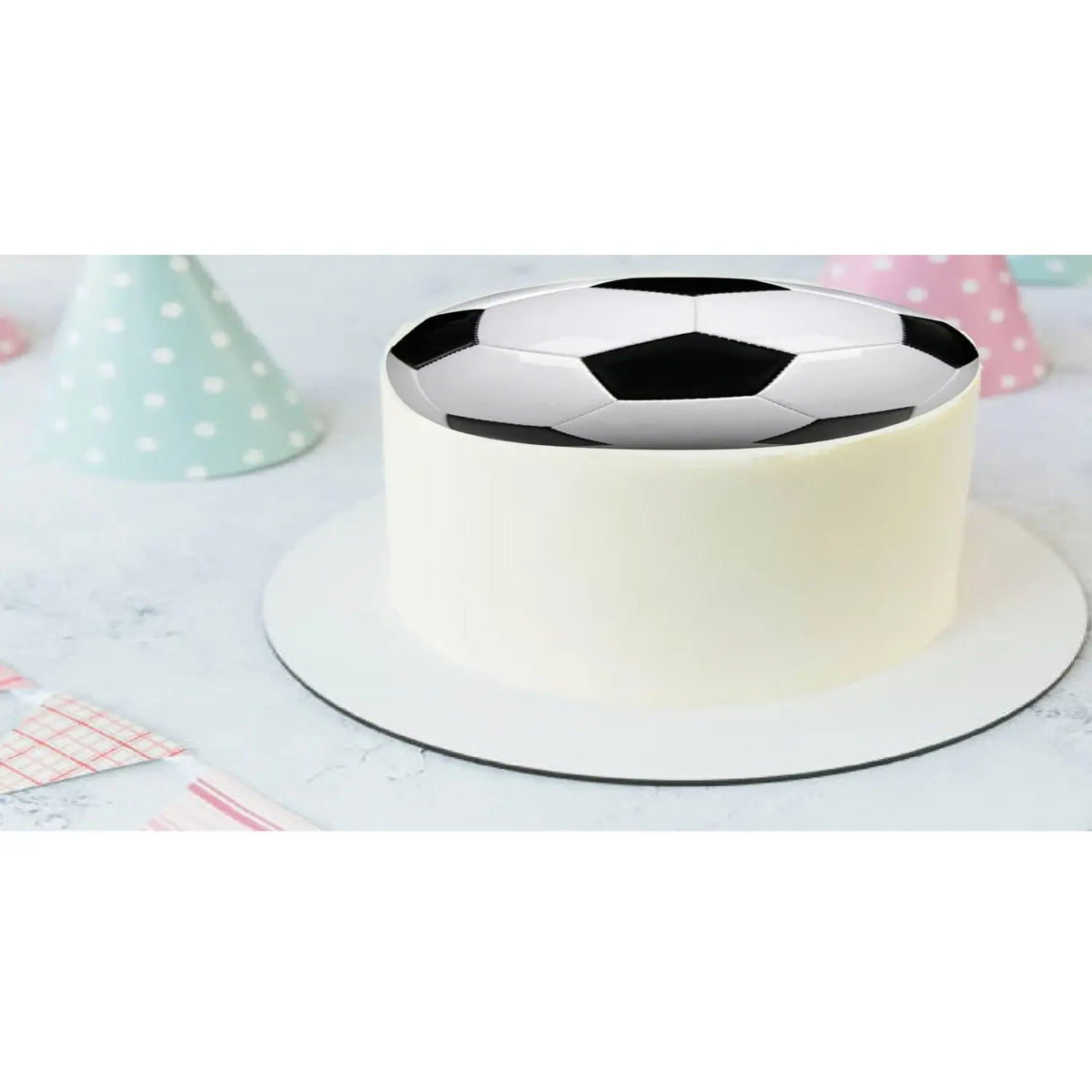 Soccer Ball Edible Icing Cake Topper, on a white frosted cake.