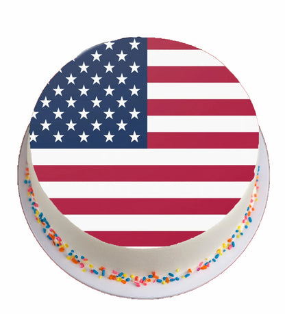 Round cake with American flag design and colorful sprinkles on a white background