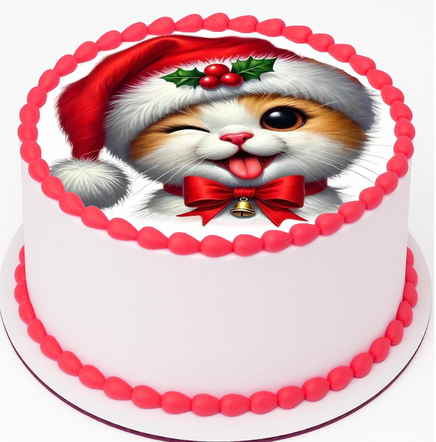 Christmas Cat Edible Cake Image on top a cake with red icing trim.  The cake image has a cat wearing a santa hat with eye winking, and tongue out, while wearing a santa hat and bow tie.