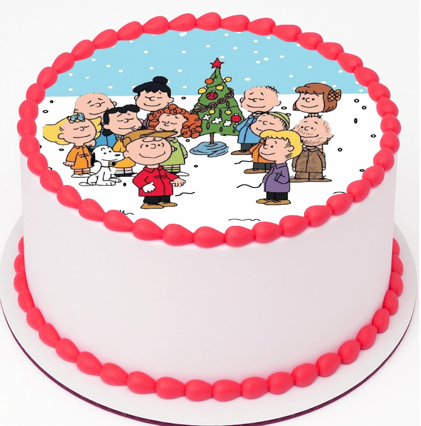 Edible Cake Image of a fun Classic Charlie Brown Christmas gathered around christmas tree on top a cake with red frosting trimming.