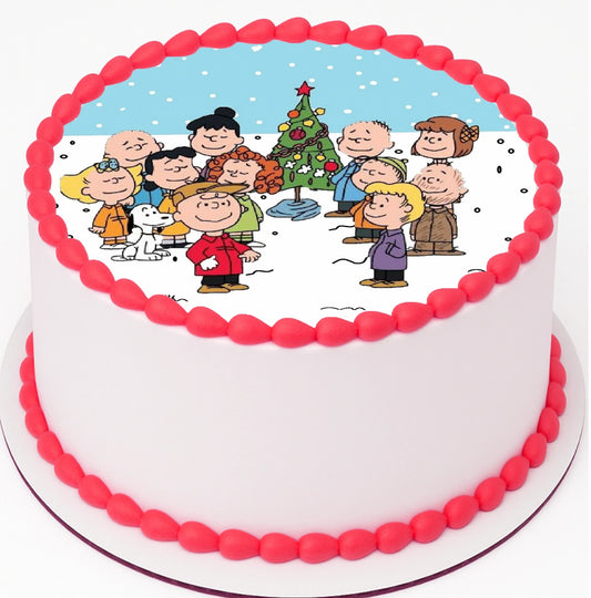 Edible Cake Image of a fun Classic Charlie Brown Christmas gathered around christmas tree on top a cake with red frosting trimming.