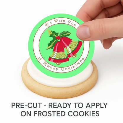 Hand placing pre-cut Christmas Bells edible cake image on frosted cookie –  holiday cookie icing sheet
