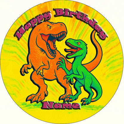 Round edible image birthday cake topper with orange and green dinosaurs.