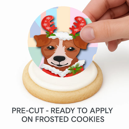 Hand placing pre-cut Christmas Canine Crew edible cake image on frosted cookie –  holiday cookie icing sheet