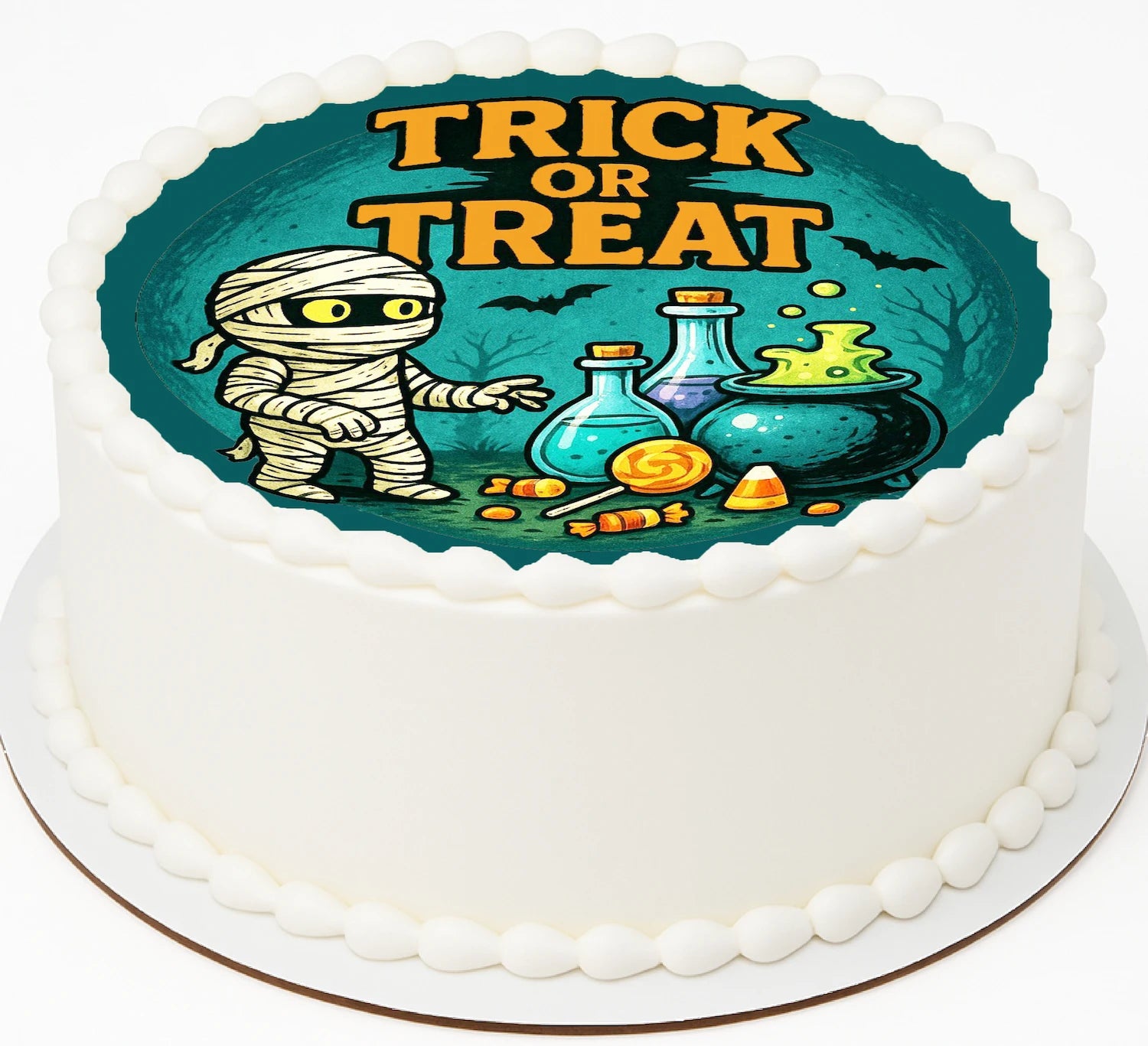 Halloween-themed cake with mummy mixing up a brew of candy and pumpkins