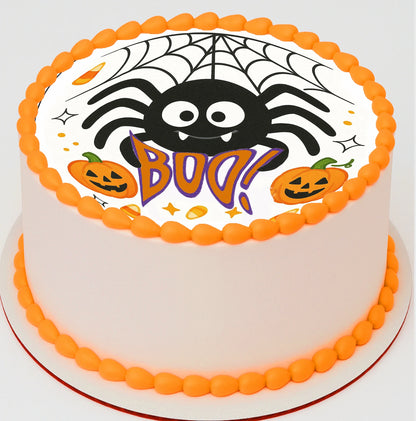 Halloween-themed cake with spider, pumpkins, and 'BOO!' text