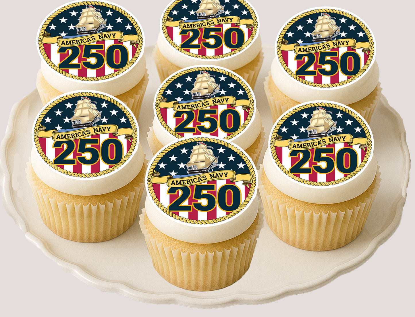 Cupcakes with America's Navy 250th anniversary edible image  toppers on a white plate.