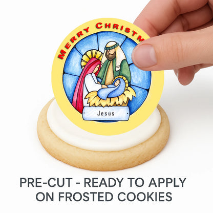 Hand placing pre-cut Christmas Nativity edible cake image on frosted cookie –  holiday cookie icing sheet