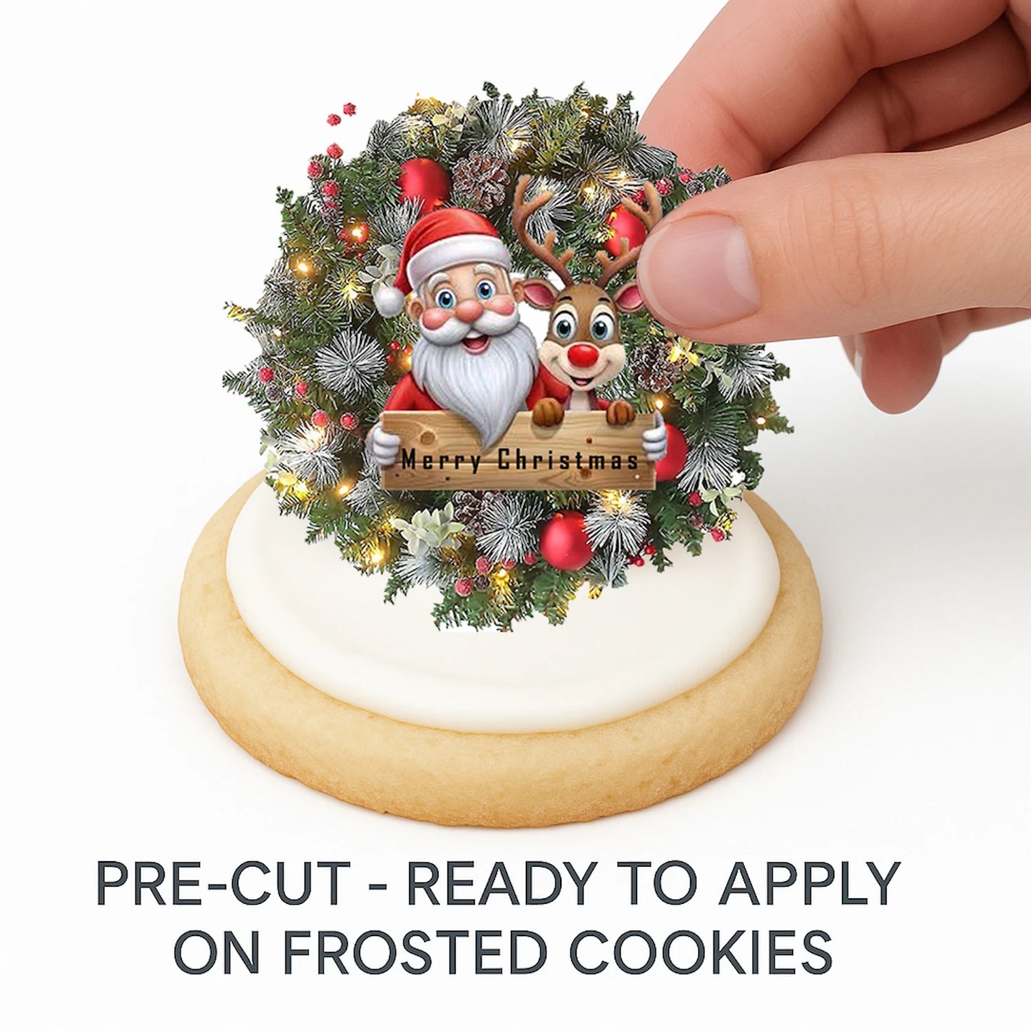 Hand placing pre-cut Christmas Santa Wreath edible cake image on frosted cookie –  holiday cookie icing sheet