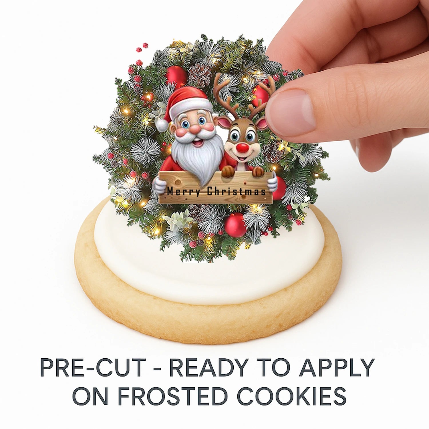 Hand placing pre-cut Christmas Santa Wreath edible cake image on frosted cookie –  holiday cookie icing sheet