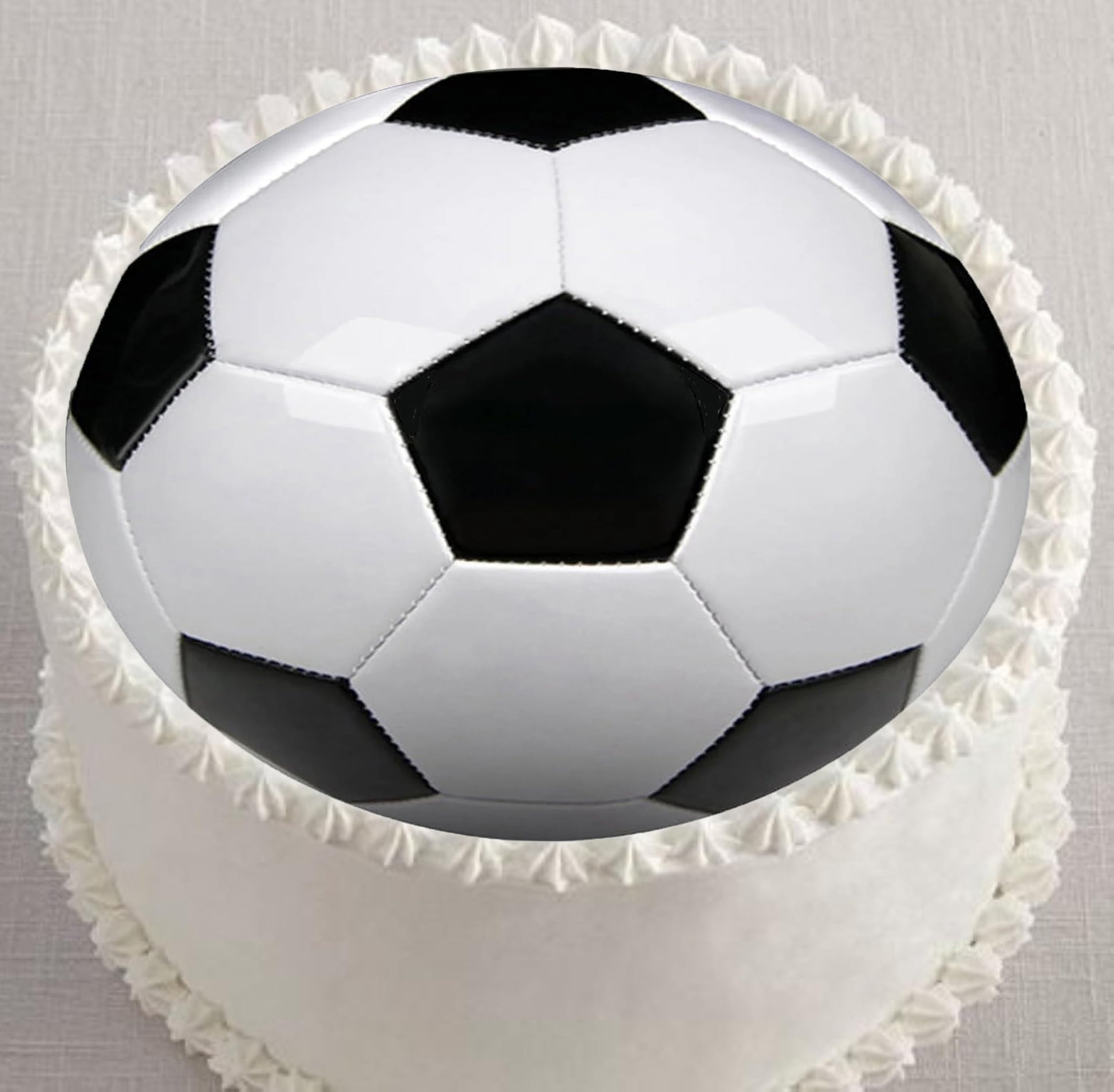 Edible image cake topper decorated like a soccer ball.