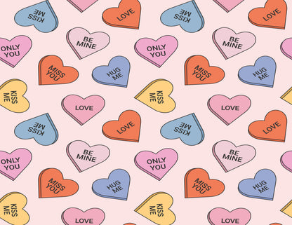 Pattern of colorful heart-shaped candy with love and affection text on a pink background