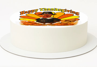 White cake with a 'Happy Thanksgiving' decoration featuring a pilgrim and pumpkins on a white background.