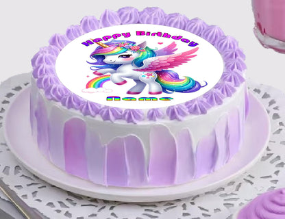 Birthday cake with a unicorn and rainbow design on a white plate.