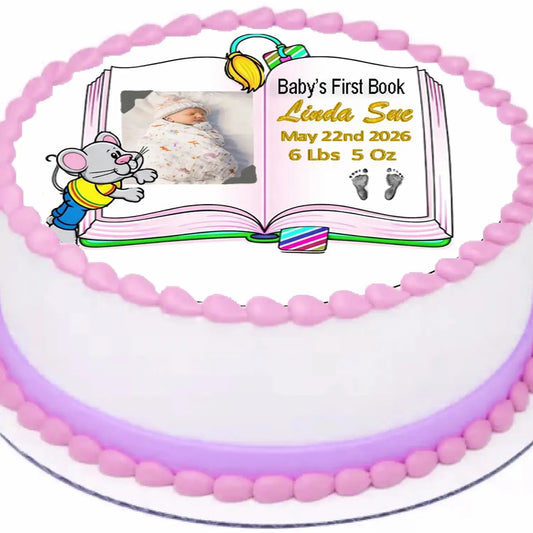 Precut 8-inch round edible icing topper with Baby's First Book design with a girl photo and birth details on a decorated cake