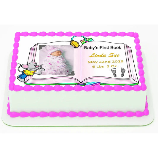 8.5 x 10.5-inch edible icing sheet with Baby's First Book design with a girl photo and birth details on a decorated cake