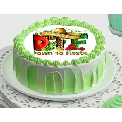 Cinco de Mayo edible icing cake topper with Down to Fiesta lettering with a sombrero, on a green frosted cake.