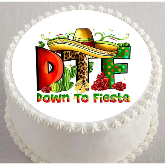Cinco de Mayo edible icing cake topper with Down to Fiesta lettering with a sombrero, on a white frosted cake.