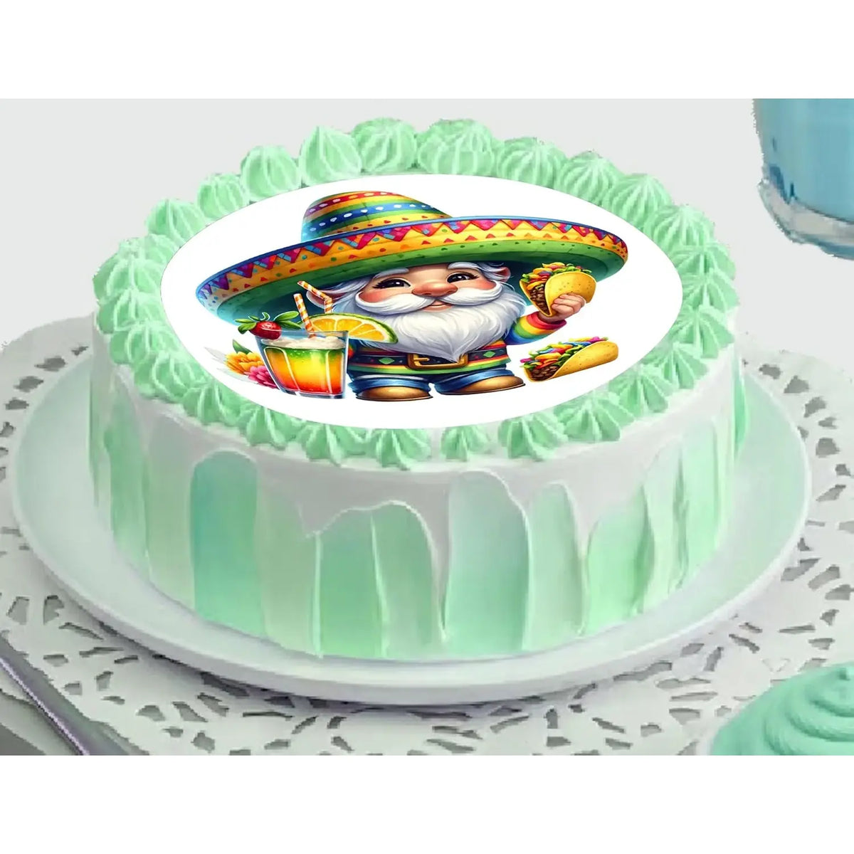 Cinco de Mayo edible icing cake topper with a fiesta gnome in a sombrero, on a green frosted cake.