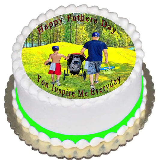 Father's Day edible icing cake topper with a father and children walking in a park, shown on a frosted cake.