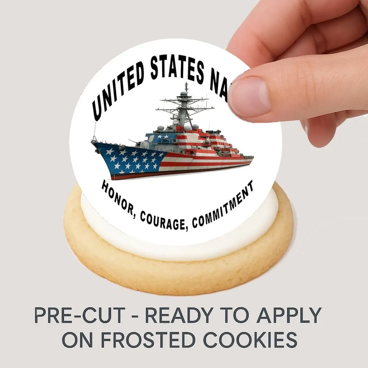 Navy Honor Courage Commitment Edible Cookie & Cupcake Toppers – 20 Precut being placed on a frosted cookie.