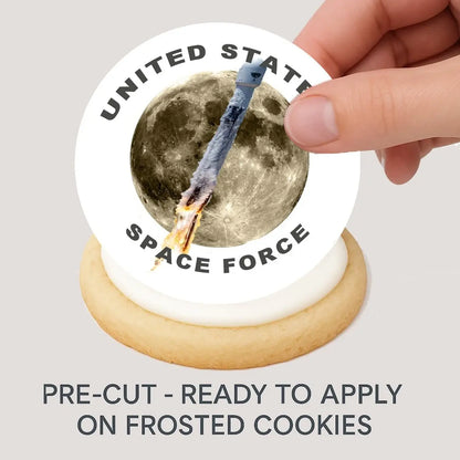 Space Force Rocket to the Moon Edible Cookie & Cupcake Toppers – 20 Precut being placed on a frosted cookie.