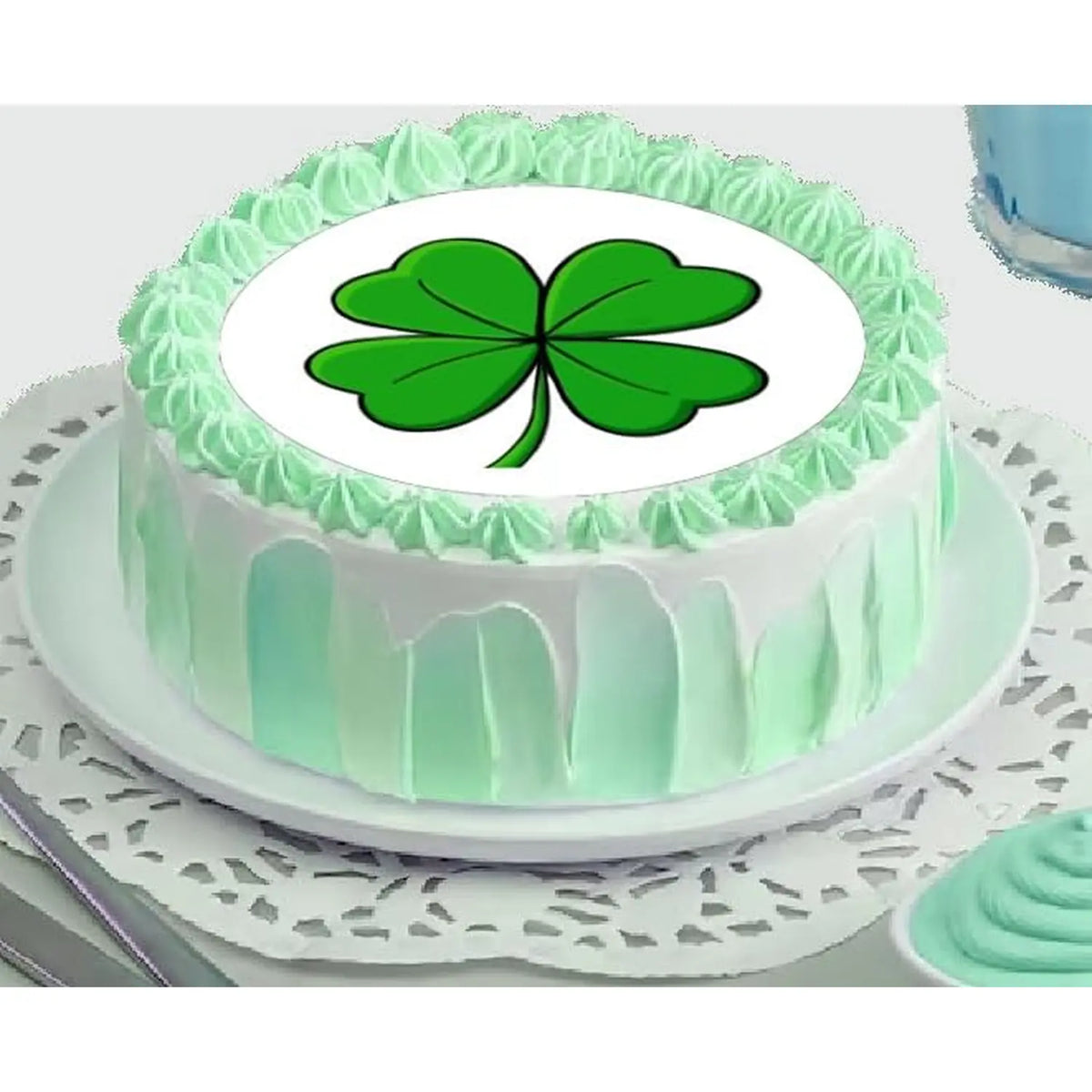 St. Patrick's Day edible icing cake topper with four-leaf clover, on a green frosted cake.